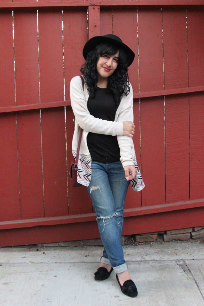 Brandy Outfit Post featuring a Tan Cardigan, Wool Hat, Black Shirt, Ripped Blue Jeans, and Black Tassel Loafers